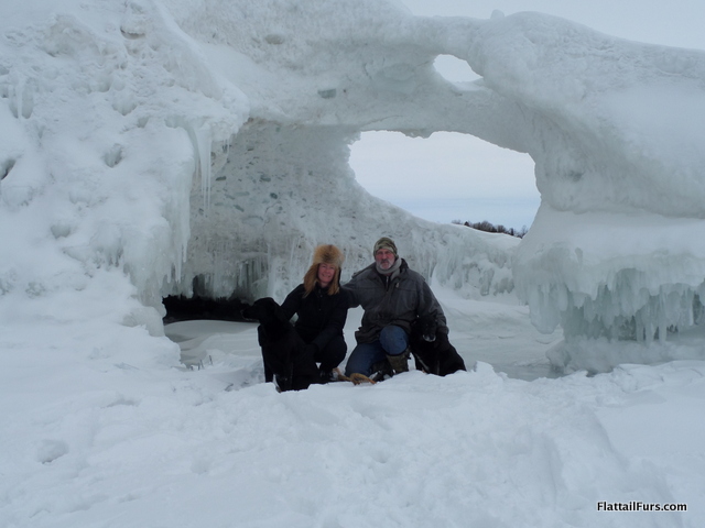 Mark, Laura, Porter, and Jetta in front of an ice cave on Beaver Island, MI.